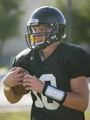 Desert Ridge's Dylan Wright holds the ball tight after making a catch during practice at Desert Ridge High School in Mesa on Aug. 10, 2015.