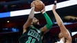 Celtics guard Kyrie Irving shoots against Pistons forward