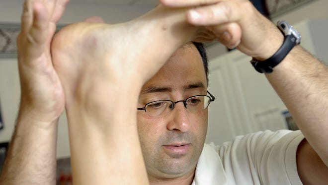 Dr. Larry Nassar works with a patient in this 2008 photo.