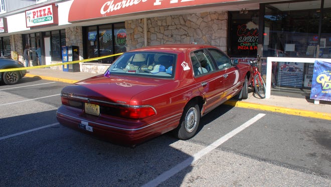 A car pinned a pedestrian to this building Friday when a driver lost control of the vehicle outside of Charlie's Pizza in Manchester, police said.