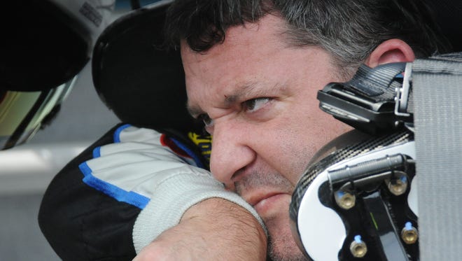 Tony Stewart wipes away the sweat after qualifying for the Brickyard 400 at the Indianapolis Motor Speedway on July 25, 2015.