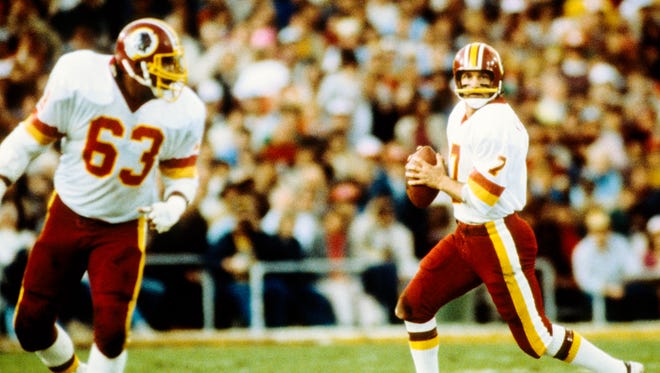 Washington Redskins guard Fred Dean in action as Joe Theismann looks to pass against the Miami Dolphins during Super Bowl XVII at the Rose Bowl. The Redskins defeated the Dolphins 27-17 in January 1983.