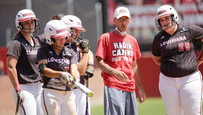 UL coach Michael Lotief is shown with members of his softball team.