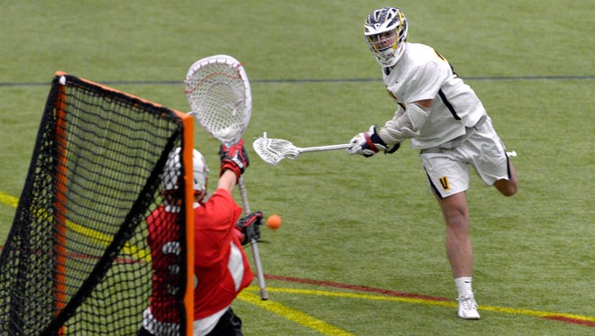 Victor’s Camden Hay, right, takes a shot on Jamesville-Dewitt goalie Liam Coyle during the season opener played at the Pinnacle Athletic Campus, Thursday, March 29, 2018. Victor beat Jamesville-Dewitt 13-10.