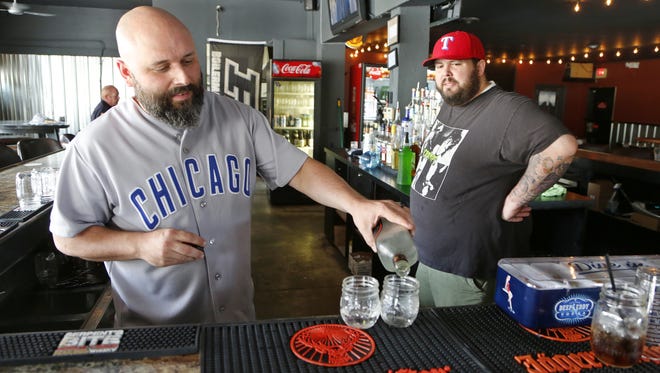 Brandon Stevens, left, pours drinks as Nick Williams looks on at Sixth Street Dive Bar & Grill Tuesday, August 30, 2016, at the corner of Sixth and Salem streets in Lafayette.