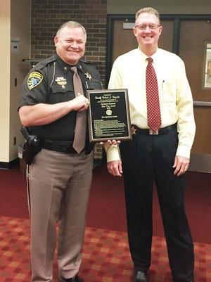 Sheriff Bob Bezotte, left, received the Hartland Optimist Annual Respect for Law Award for his continued support of youth programs throughout the county. Also pictured is Undersheriff Mike Murphy.