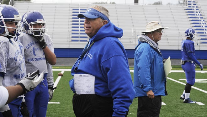 Chillicothe football coach Ron Hinton talks with his offense while his defensive coordinator Jeff Arndt watches the current play during a practice at Herrnstein Field in 2013.