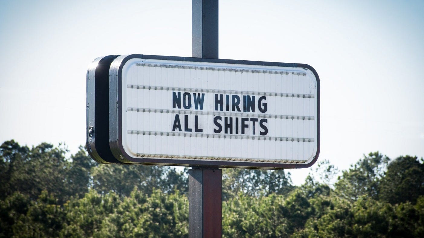 Sign that reads now hiring all shifts.