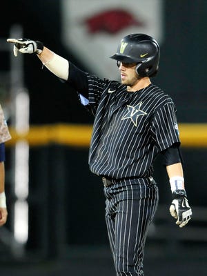 Vanderbilt's Dansby Swanson salutes after hitting a RBI double against Virginia during the 7th inning in the College World Series at TD Ameritrade Park, Monday, June 22, 2015, in Omaha, Neb.
