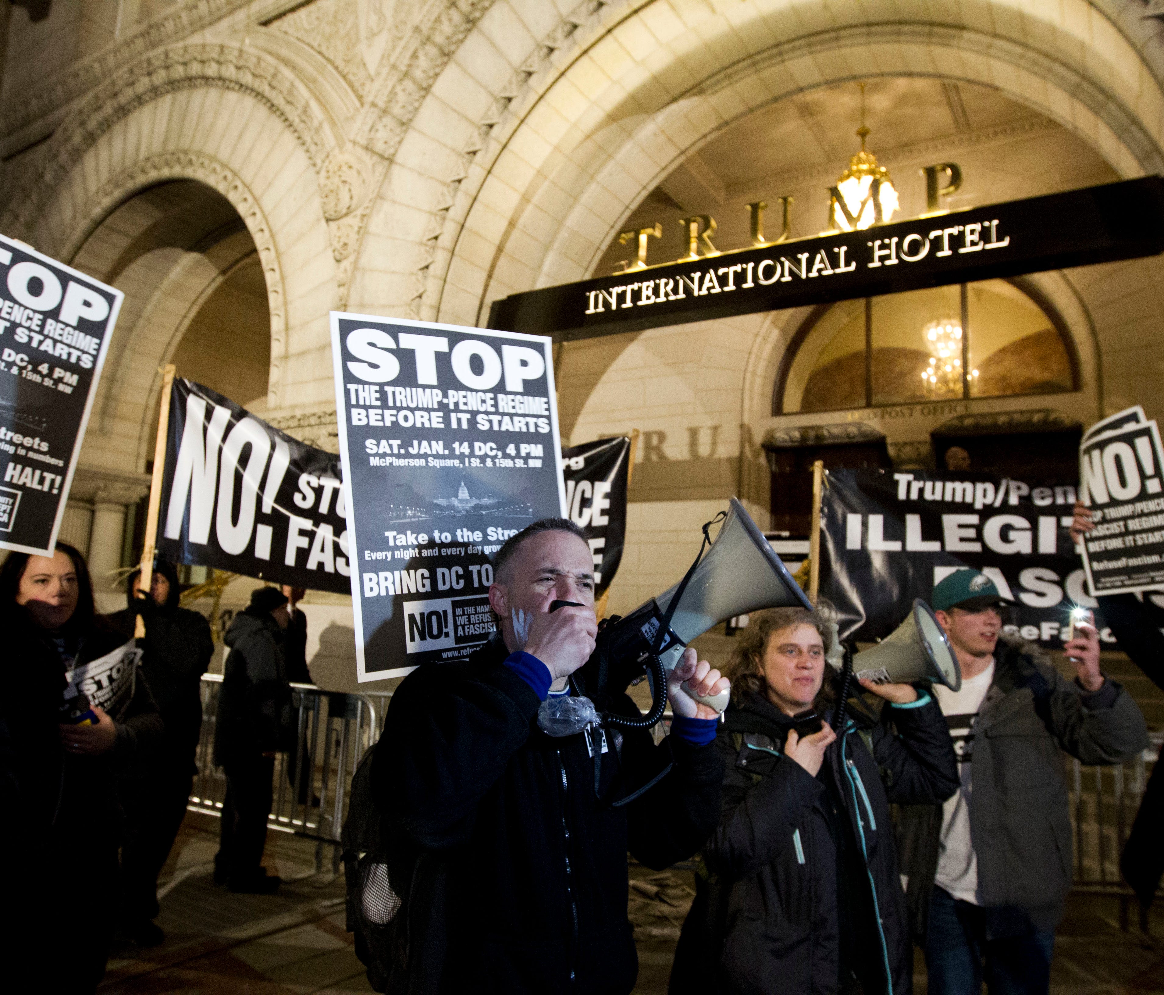 Demonstrators protest outside of the Trump International Hotel during a march in downtown Washington in opposition of President-elect Donald Trump on Jan. 15, 2017.