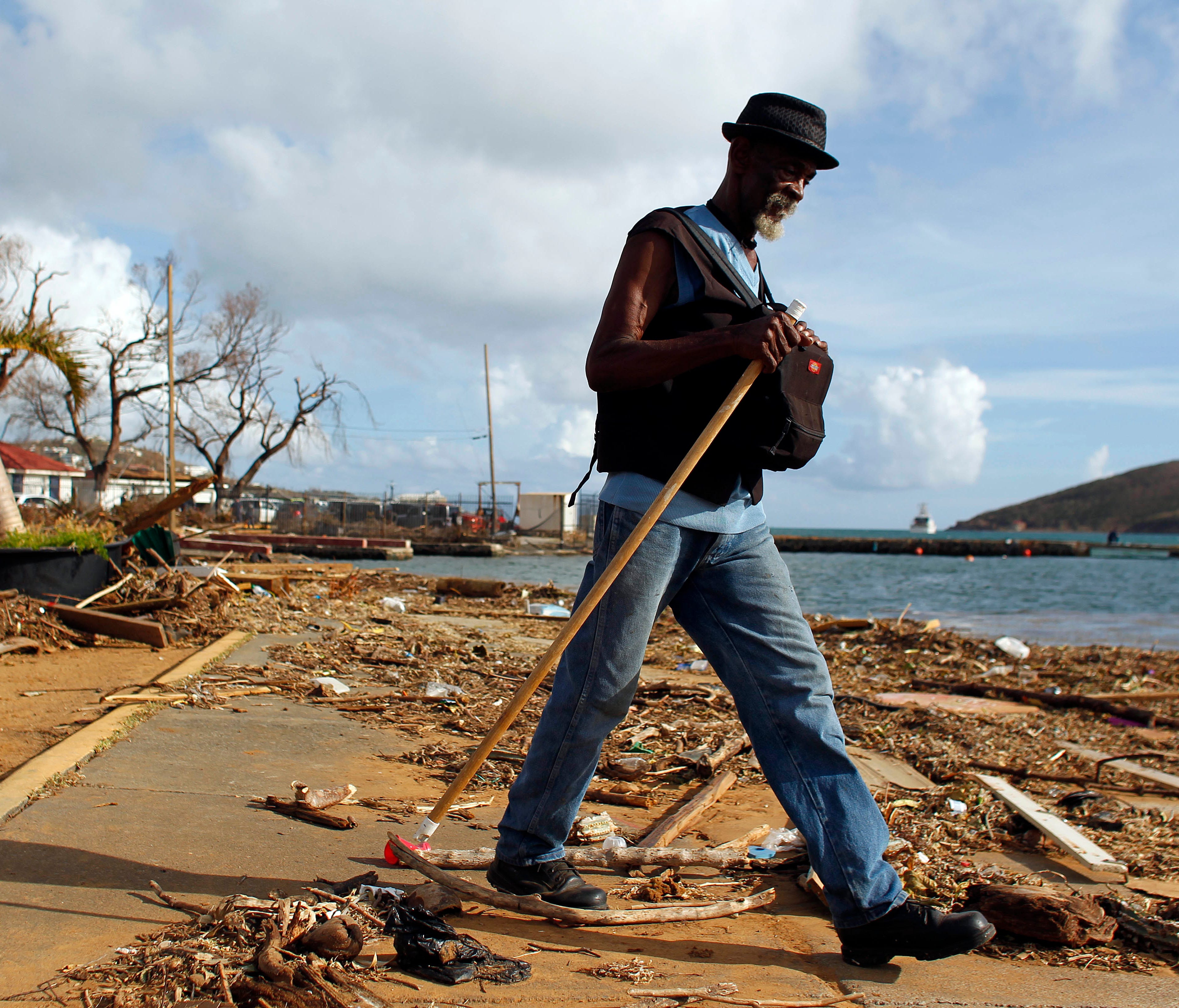 A man walks past debris caused by Hurricane Irma in Charlotte Amalie, St. Thomas, U.S. Virgin Islands, on Sept. 10, 2017.  The storm ravaged such lush resort islands as St. Martin, St. Barts, St. Thomas, Barbuda and Anguilla.