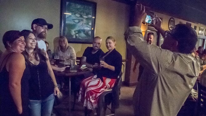 Patrons pose for pictures during the last night for Arcadia at the 103 W. Michigan Ave. location in Battle Creek.