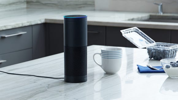 An Amazon Echo sits on a kitchen counter.