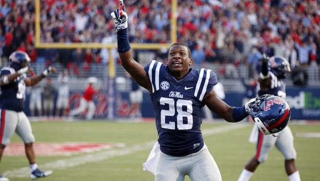 Mississippi defensive back Mike Hilton (28) celebrates his team's 23-17 win over No. 3 Alabama in an NCAA college football game in Oxford, Miss., Saturday, Oct. 4, 2014. (AP Photo/Rogelio V. Solis)