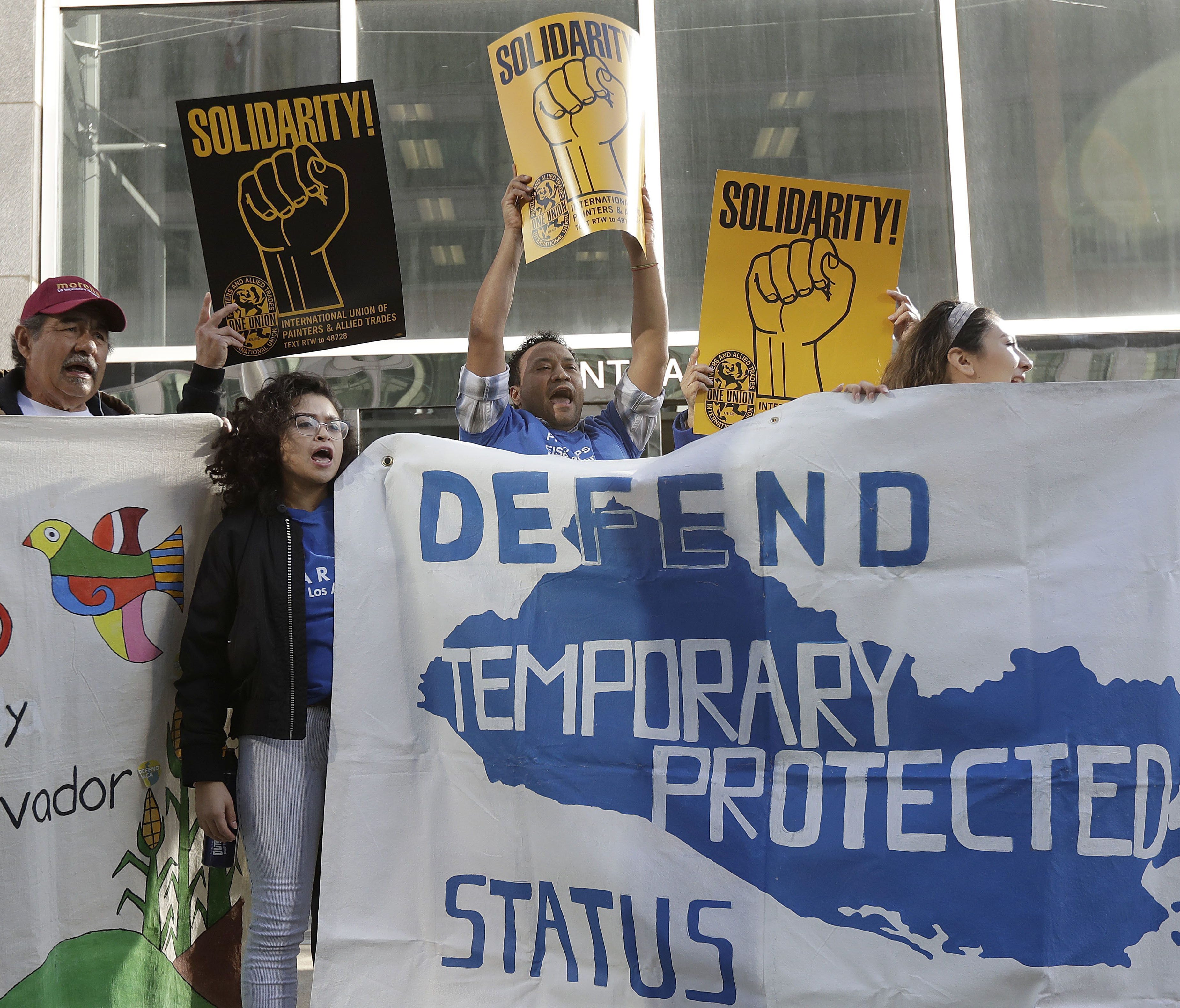 Supporters of Temporary Protected Status immigrants chant at a rally in San Francisco on March 12, 2018, before a news conference announcing a lawsuit against the Trump administration over its decision to end the program that lets immigrants live and