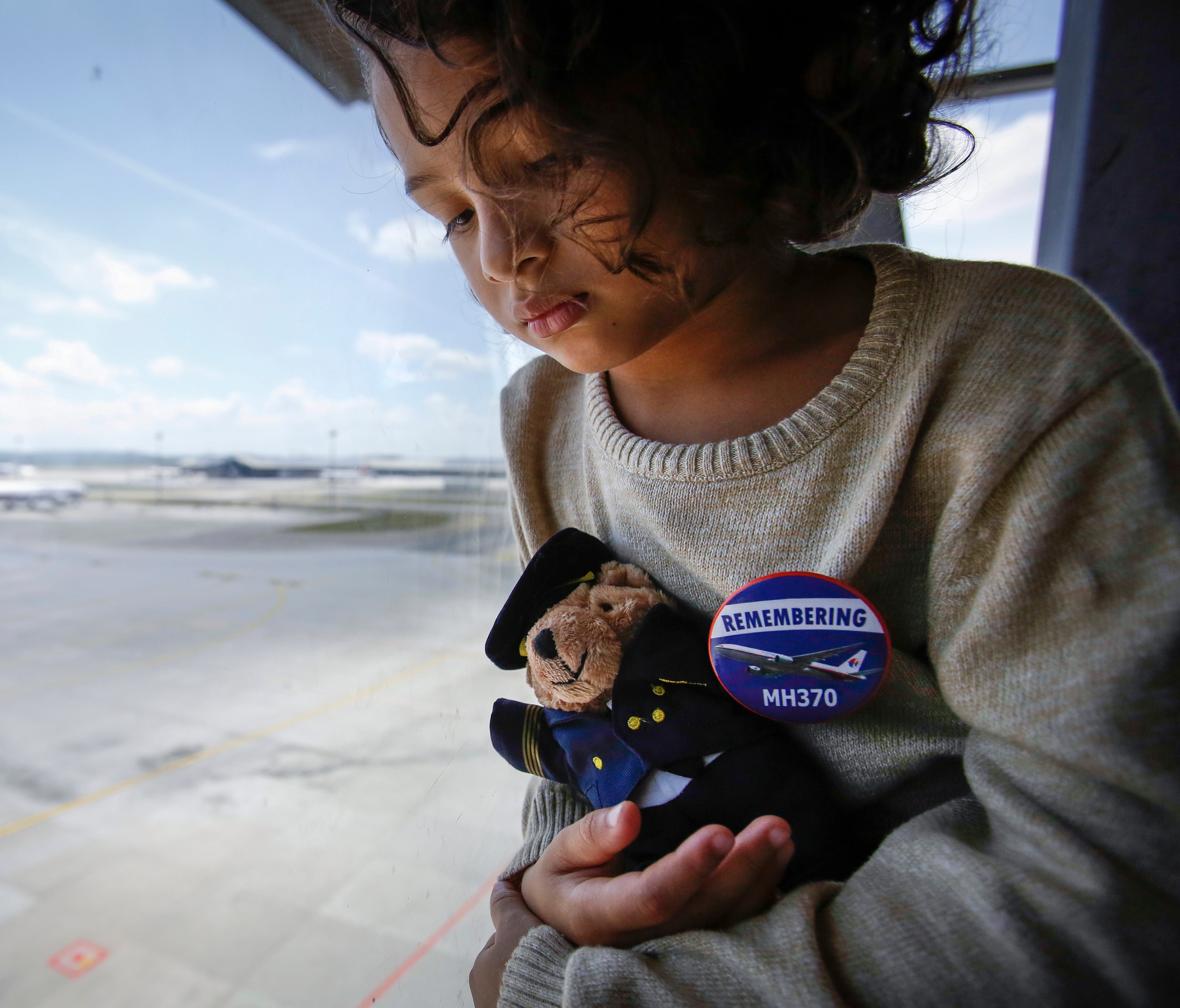 Raphael Ariano, 5, grandson of Patrick Gomes, inflight supervisor on the ill fated Malaysia Airlines Flight 370, holds a soft toy after a memorial service for the second anniversary of the jet's March 8, 2014, disappearance, at the Kuala Lumpur Inter