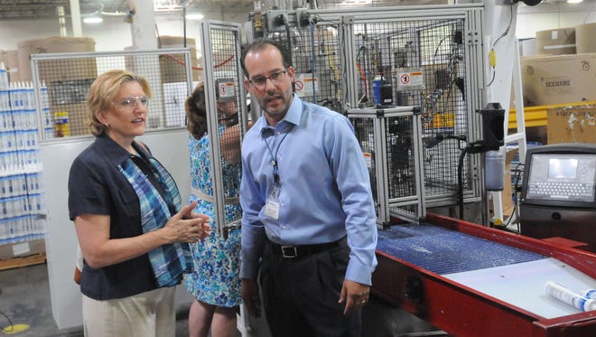 Fortifiber president Chris Yount shows USDA Rural Development state director Sarah Adler some of the equipment the company uses to make its products during a tour in Fernley in 2015.