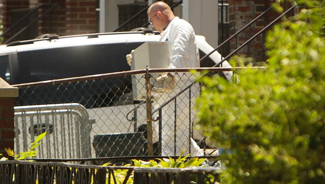 Crime scene investigators collect evidence  on July 14, 2011 from the home of Levi Aron, who later pleaded guilty to abducting and killing 8-year-old boy Leiby Kletzky, in the Brooklyn borough of New York.