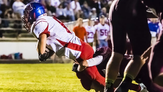 Hunter Holbrook of Mason falls over the goal line for a touchdown in the 3rd quarter of the Bulldogs'  game with Eaton Rapids Friday September 6, 2013 in Eaton Rapids.