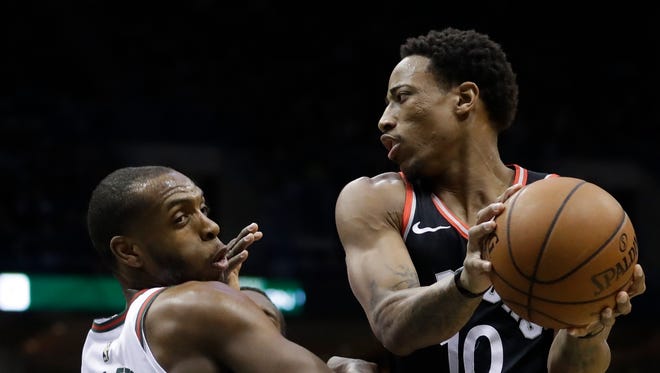 Khris Middleton of the Bucks watches as DeMar DeRozan of the Raptors drives past him during the first half on Friday night.