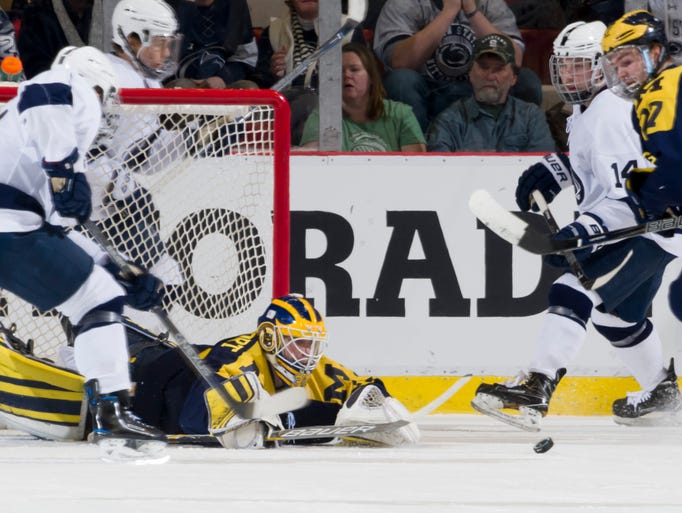 Michigan goalie Zach Nagelvoort reaches out to make