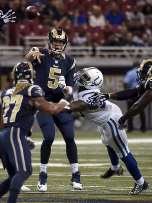 St. Louis quarterback Nick Foles, left, throws under pressure from Indianapolis linebacker Trent Cole. Foles finished 10-of-11 for 128 yards passing and a touchdown.