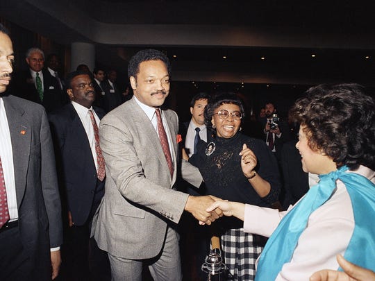 Democratic presidential candidate Jesse Jackson greets supporters after a rally at UAW Local 212 on the east side of Detroit, Friday, March 25, 1988. Jackson won the Michigan Democratic caucuses that year.