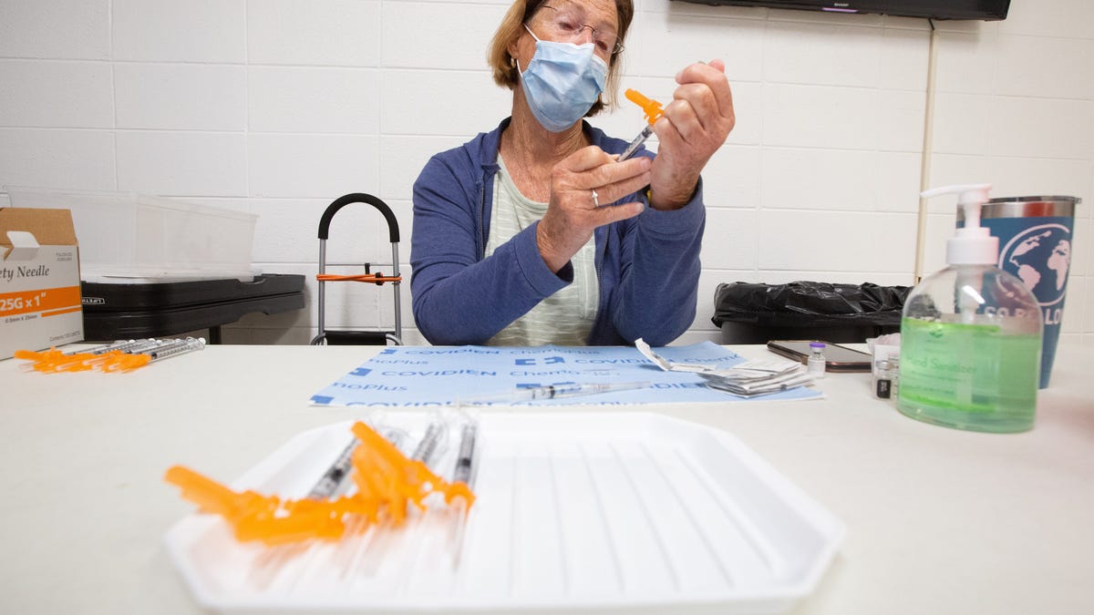 Manya Schmidt, volunteer nurse with the Shawnee County Health Department in Kansas, loads vials of the Pfizer COVID-19 vaccine during a clinic July 28.