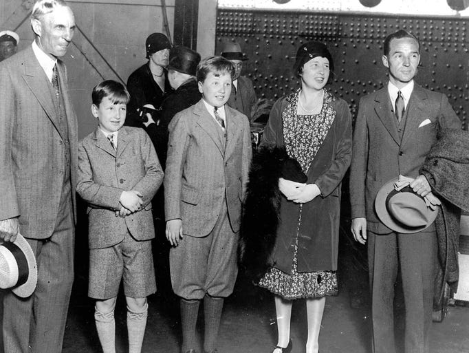 Henry Ford is greeting Edsel Ford and family, including