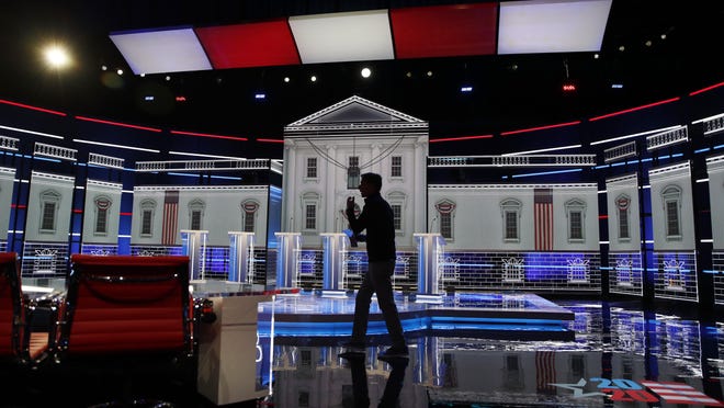 A person walks across the stage during setup for the Nevada Democratic presidential debate Tuesday, Feb. 18, 2020, in Las Vegas.