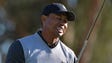 Tiger Woods reacts after teeing off the 15th hole during