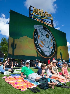 Fans stretch out on the lawn at the San Francisco Giants vs. Oakland Athletics game at Hohokam Stadium in Mesa on Tuesday, March 3, 2015.