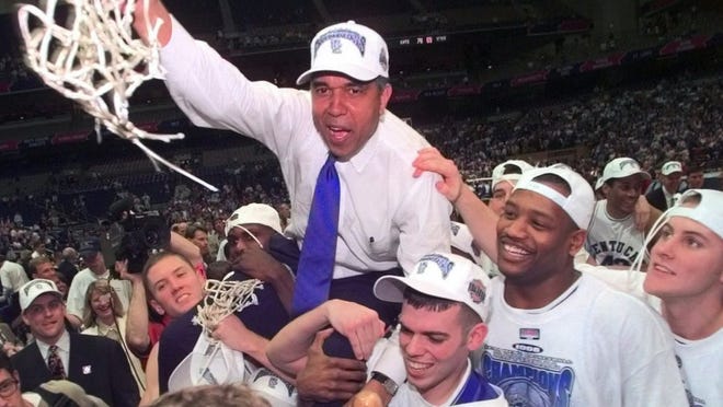 In this March 30, 1998, file photo, Kentucky coach Tubby Smith is carried off the court by game MVP Jeff Sheppard, left, Steve Masiello, center right, and Jamaal Magloire second from right front, after Kentucky defeated Utah for the NCAA men's college basketball championship at the Alamodome in San Antonio.