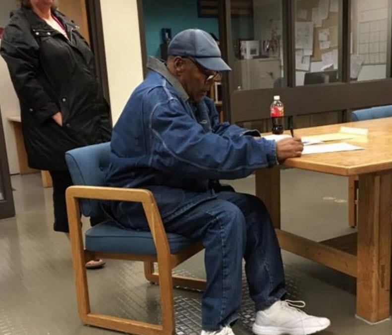 O.J. Simpson signs documents before leaving Lovelock Correctional Centre early Sunday.