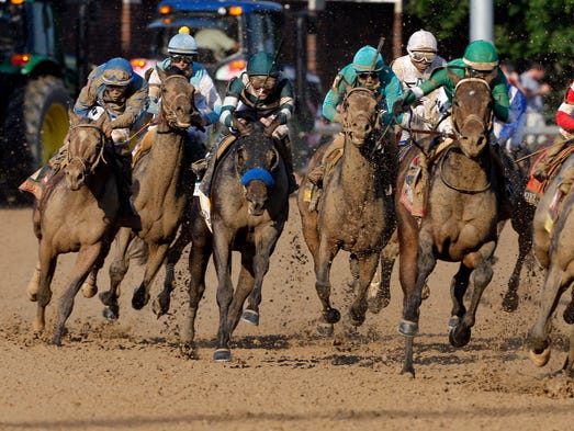 Luis Saez aboard Brody's Cause (left) races in the pack during the ...