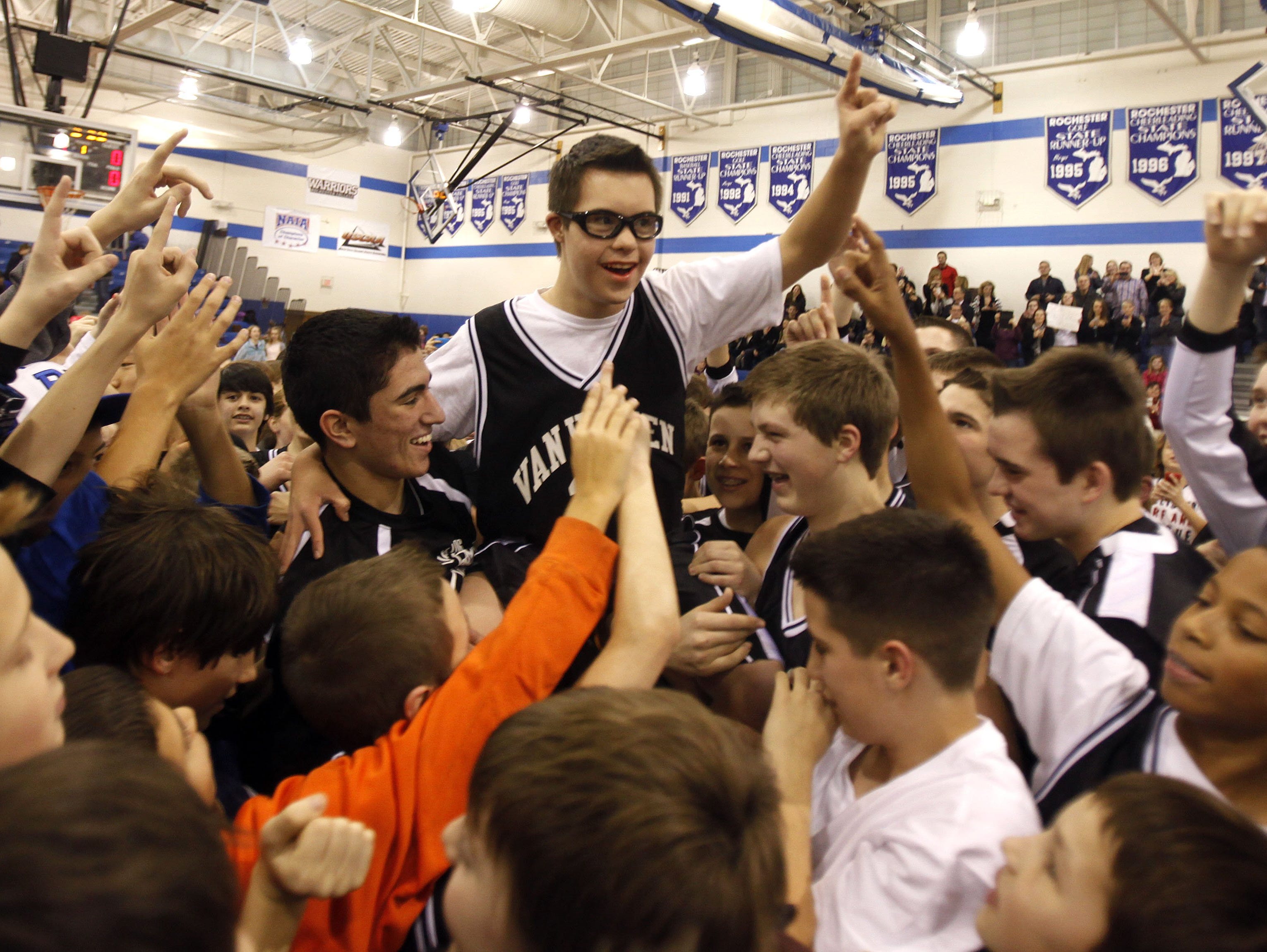 Members of the Van Hoosen Middle School basketball team hoist Owen Grosser, an eighth grader, onto their shoulders after playing against Reuther Middle School at Rochester High School in Rochester, Mich., on Thursday, Jan. 24, 2013. Grosser made Sports Center top ten highlights by scoring three three's in a row. ANDRE J. JACKSON/Detroit Free Press