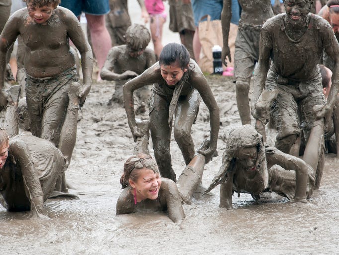 The kids line up to participate in a wheelbarrow contest.