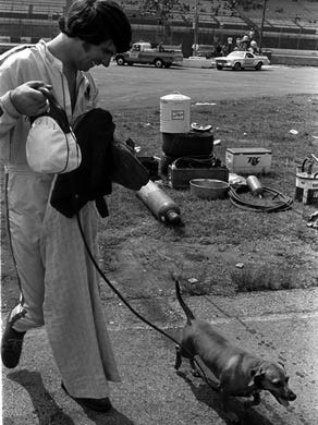 Driver Darrell Waltrip takes his dog for a walk before