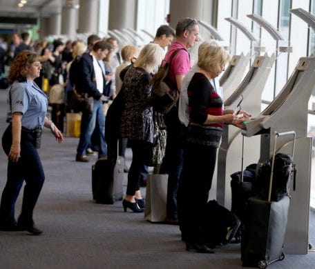 Passengers use the Automated Passport Control Kiosks set up for international travelers arriving at Miami International Airport on March 4, 2015 in Miami, Fla.