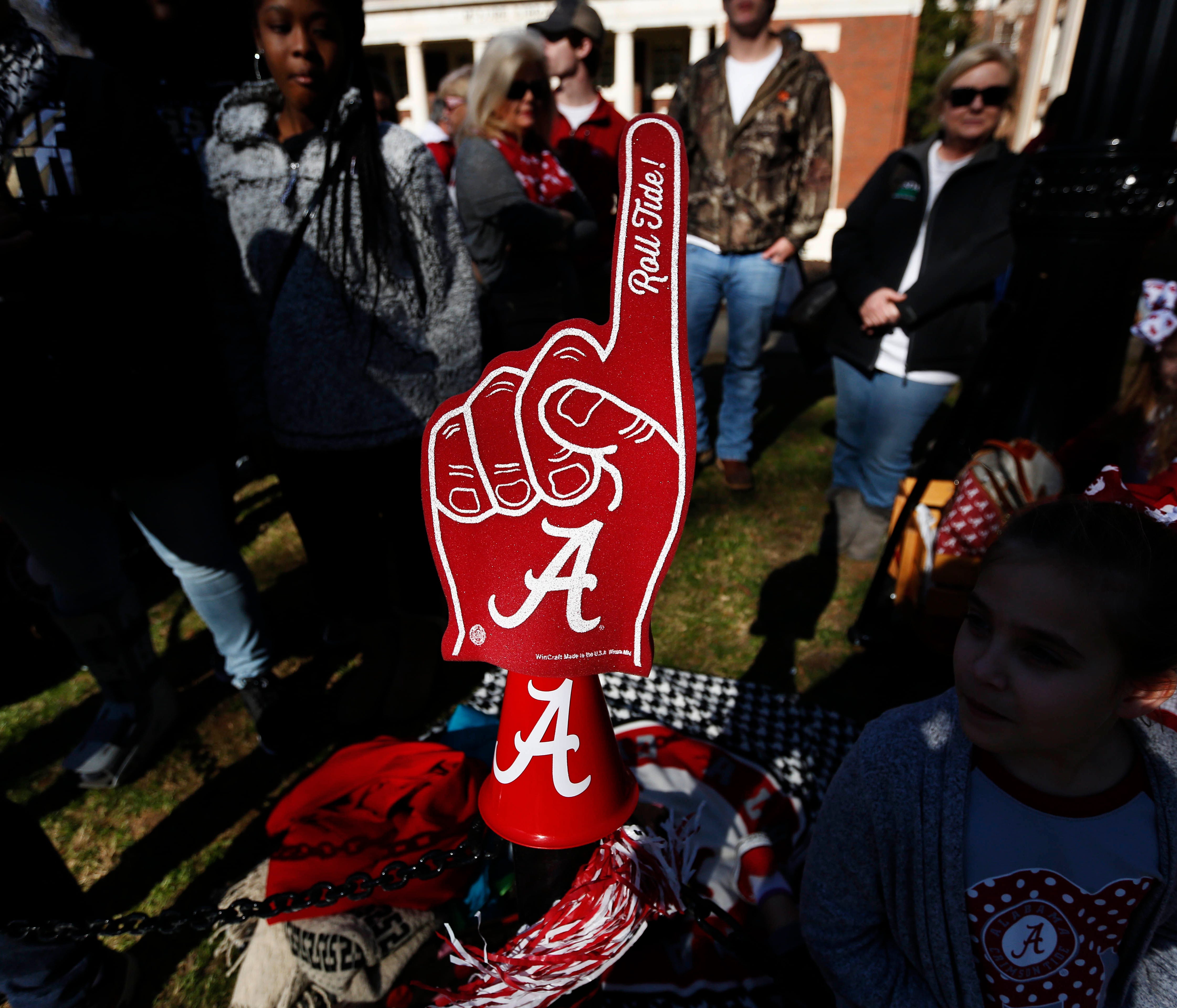 A fan placed a foam finger on a sidewalk gate before the NCAA college football national championship parade, Saturday, Jan. 20, 2018, in Tuscaloosa, Ala. Alabama won the national championship game against Georgia 26-23 in overtime. (AP Photo/Brynn An