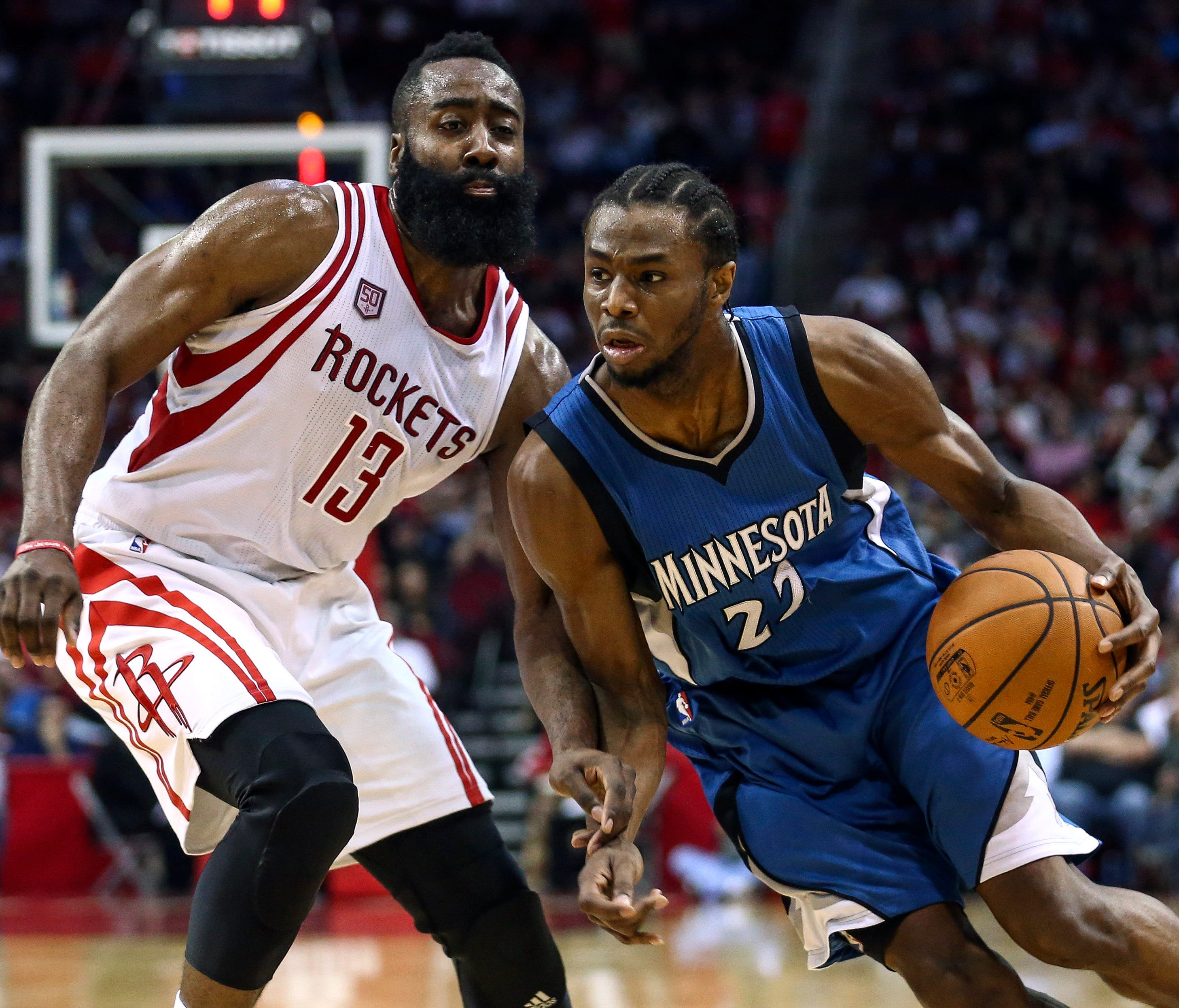 Minnesota Timberwolves forward Andrew Wiggins (22) attempts to drive the ball around Houston Rockets guard James Harden (13) during the third quarter at Toyota Center.