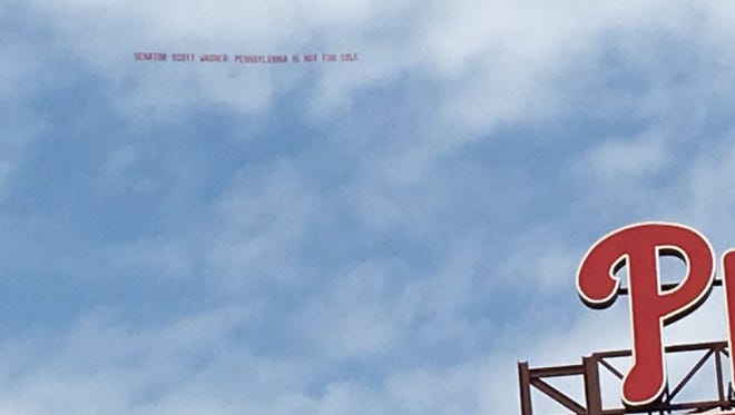 Sen. Scott Wagner's name was mentioned in a banner that was seen flying about an hour ahead of the 3 p.m. Philadelphia Phillies opening game on Monday.