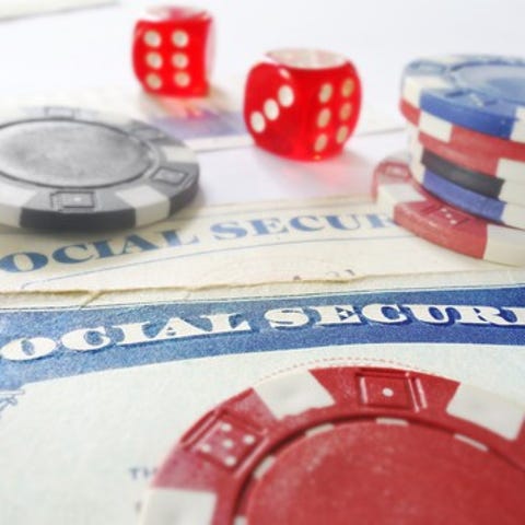 Dice and casino chips lying atop Social Security...