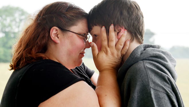 Rosanna Drayer embraces her son Xaiver Smith, 11, outside the family's Monaghan Township home. Drayer, 33, is a single mother of three children, who qualify for free meals at school through the federal school lunch program. The family is part of a growing York County population struggling to make ends meet.