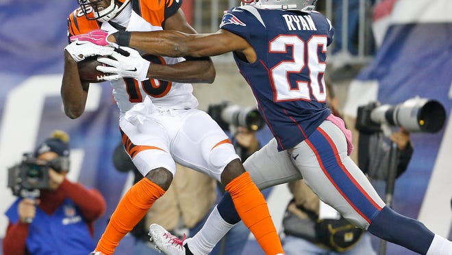 Cincinnati Bengals wide receiver A.J. Green (18) catches a touchdown pass in front of New England Patriots cornerback Logan Ryan (26) during the third quarter of their game played at Gillette Stadium in Foxborough, Massachusetts Sunday October 5, 2014. The Enquirer/Gary Landers