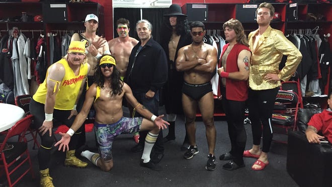 Rochester Red Wings relievers dress as wrestlers to meet former pro wrestler Bret Hart before Monday’s game. From left: Logan Darnell, A.J. Achter, Mark Hamburger, Ryan O’Rourke, Bret Hart, Alex Meyer, Lester Oliveros, Caleb Thielbar and Michael Tonkin.