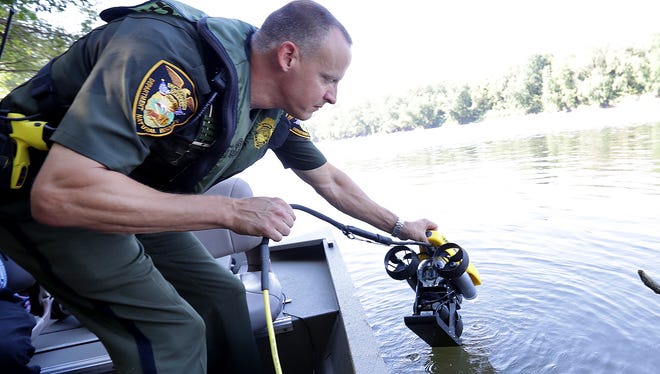 Indiana Conservation officer Jim Hash launches his ROV, remotely operated vehicle, into the Wabash River in Terre Haute.  Indiana Conservation officers and dive team members go through training on the Wabash River Thursday, September 22, 2016, morning in Terre Haute IN.