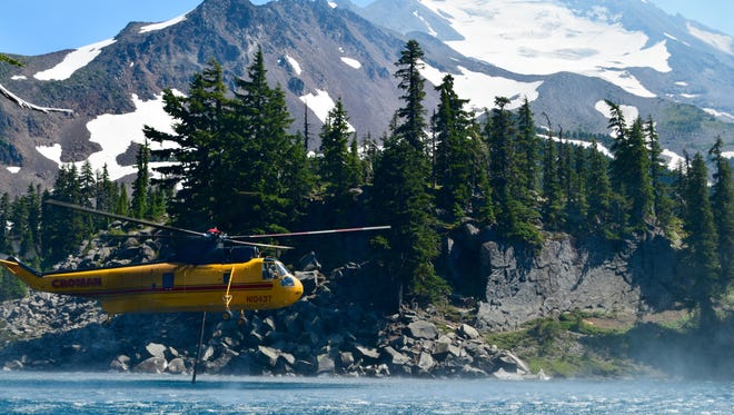 Helicopters lift water from a lake in Jefferson Park, in the Mount Jefferson Wilderness, to fight the Whitewater Fire.