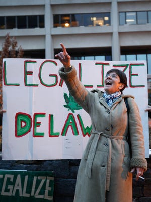 Delaware NORML executive director Cynthia Ferguson points up to lawmakers in the Louis L. Redding City/County building before leading a march through Wilmington in 2014 in support of marijuana decriminalization and legalization.