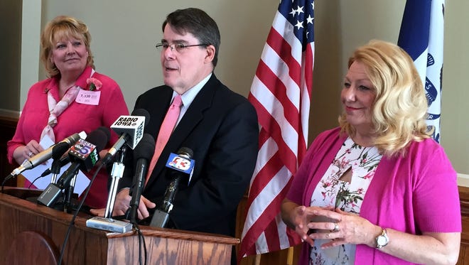Many Democratic legislators wore pink clothing at the Iowa Capitol on April 29, 2015, to express solidarity with teachers who had received pink slips, or layoff notices. From left to right are: Rep. Cindy Winckler of Davenport, Senate Majority Leader Michael Gronstal of Council Bluffs, and Senate President Pam Jochum of Dubuque.